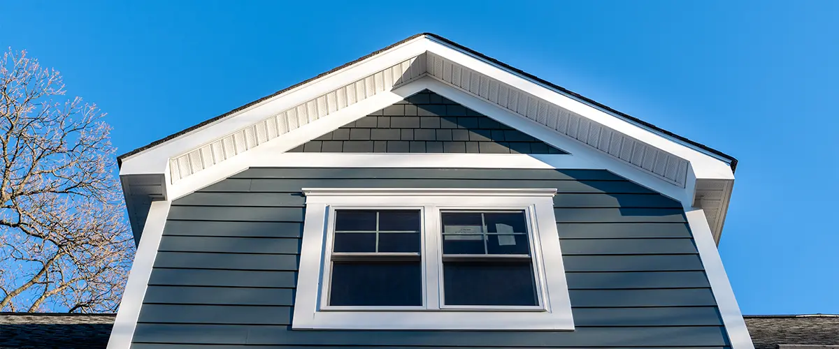 Double hung windows with green home siding