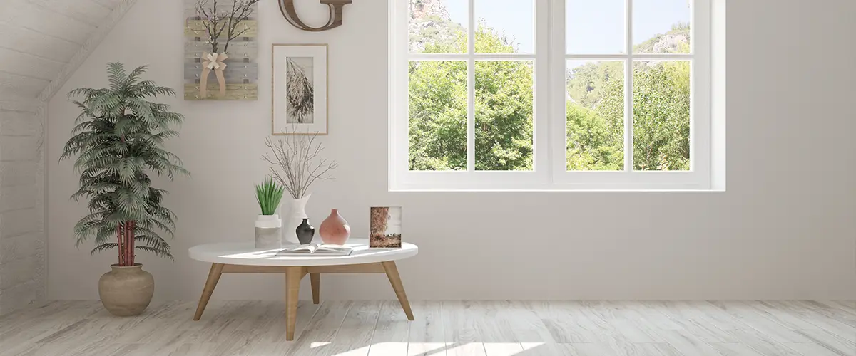A white window frame for a room with a plant and a small table