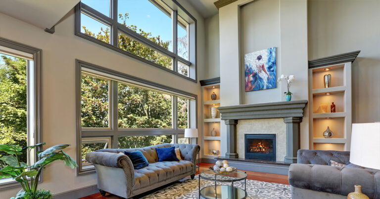 Elegant living room with large windows, modern art, and fireplace