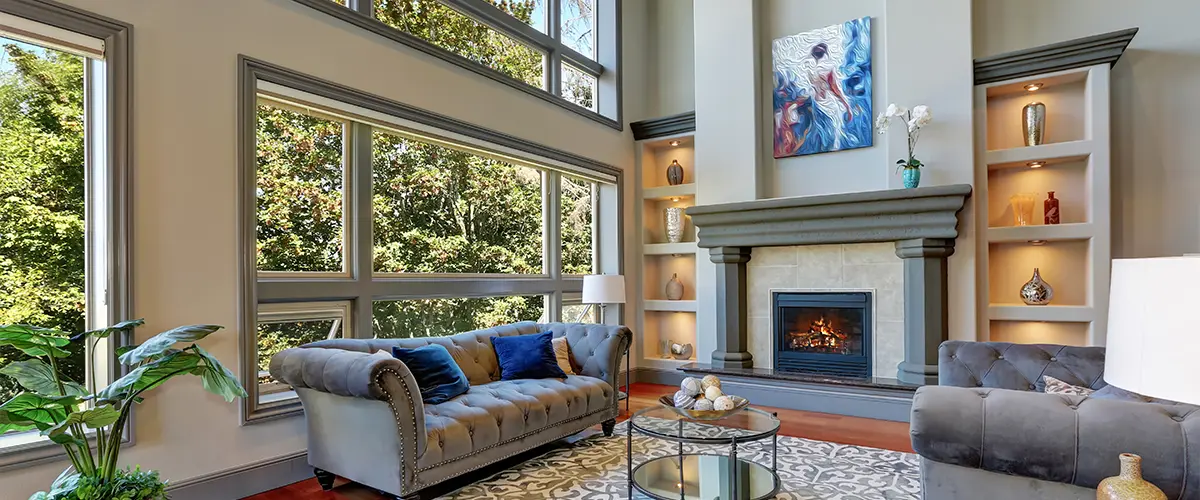 Elegant living room with large windows, modern art, and fireplace