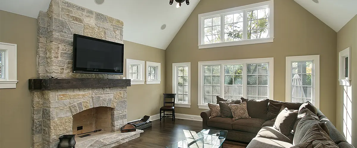Living room with new Window Replacement in Shackle Island, TN, stone fireplace.