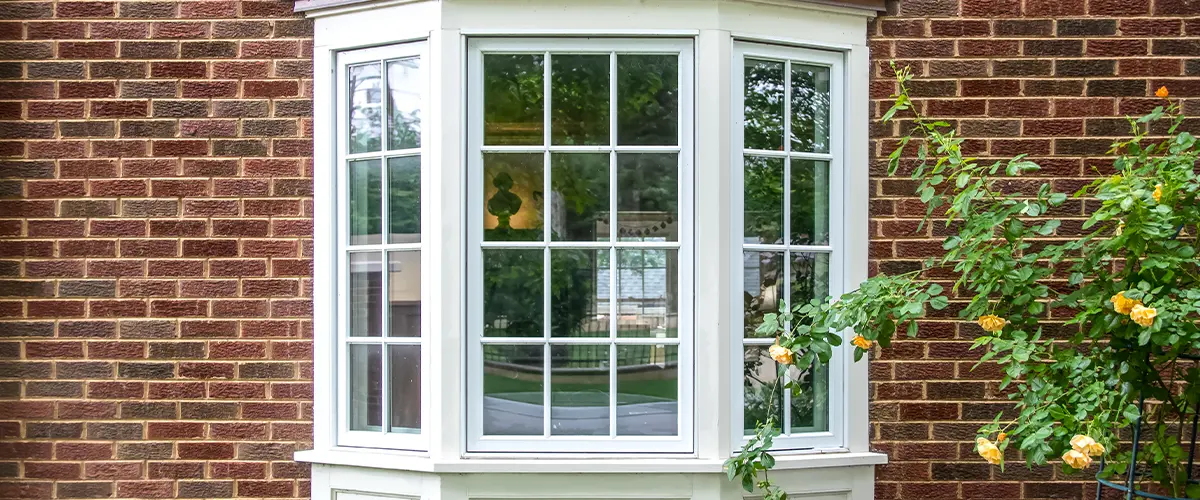 bay window on brick house and garden