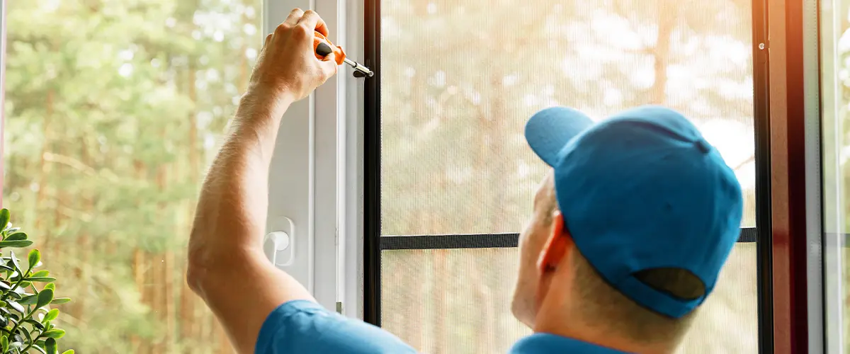 worker installing screen-window in home