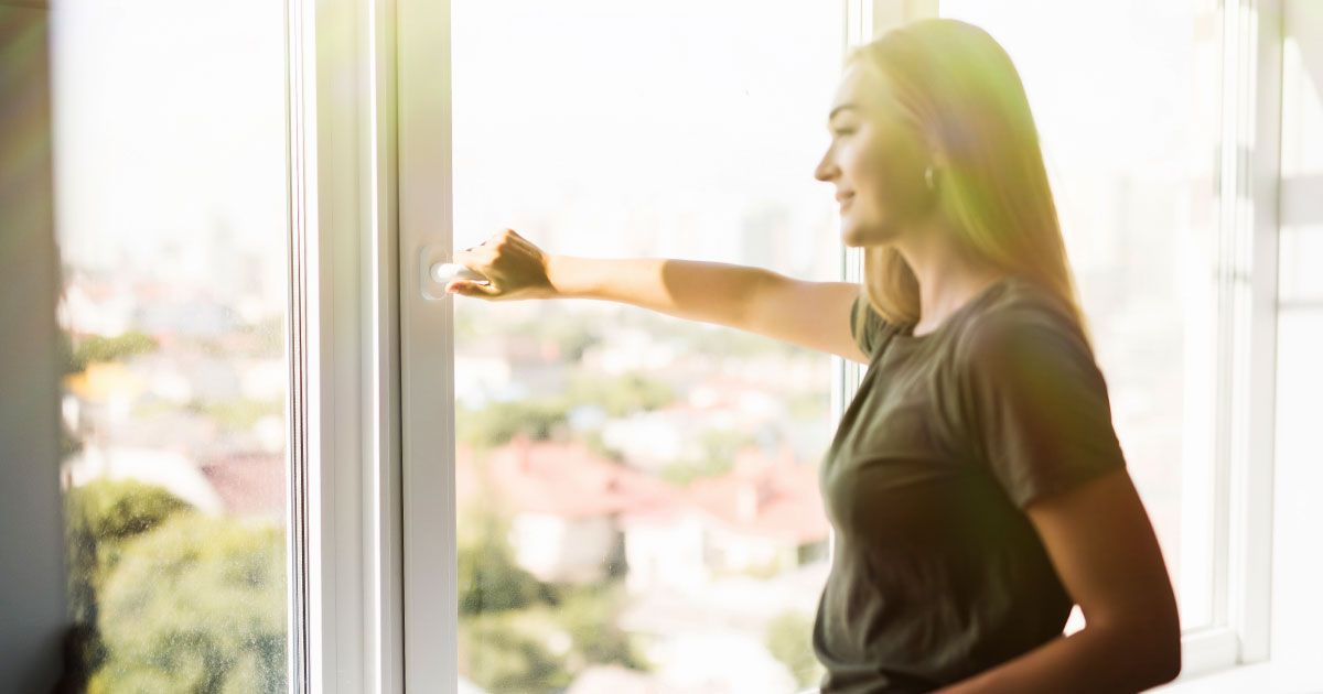 Woman opening an argon gas windows window