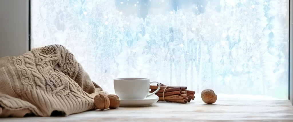 A window covered in ice and frost, indicating winter time