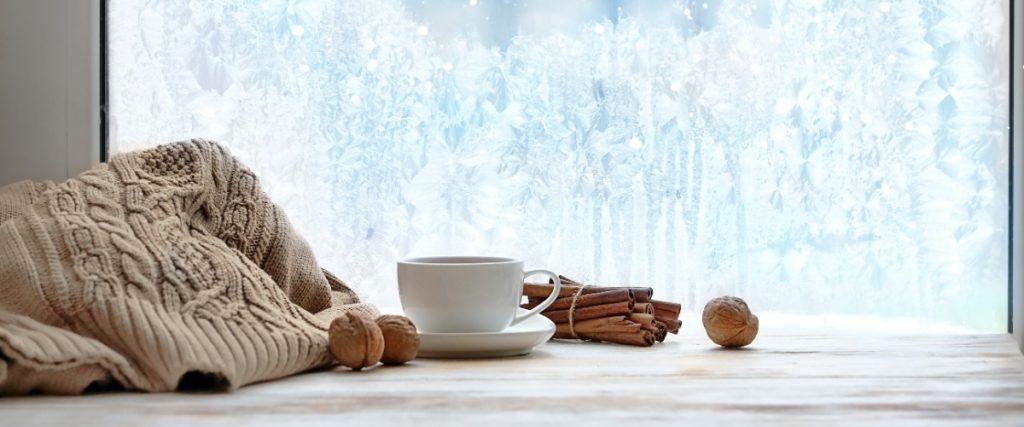 a cozy winter scene by a window