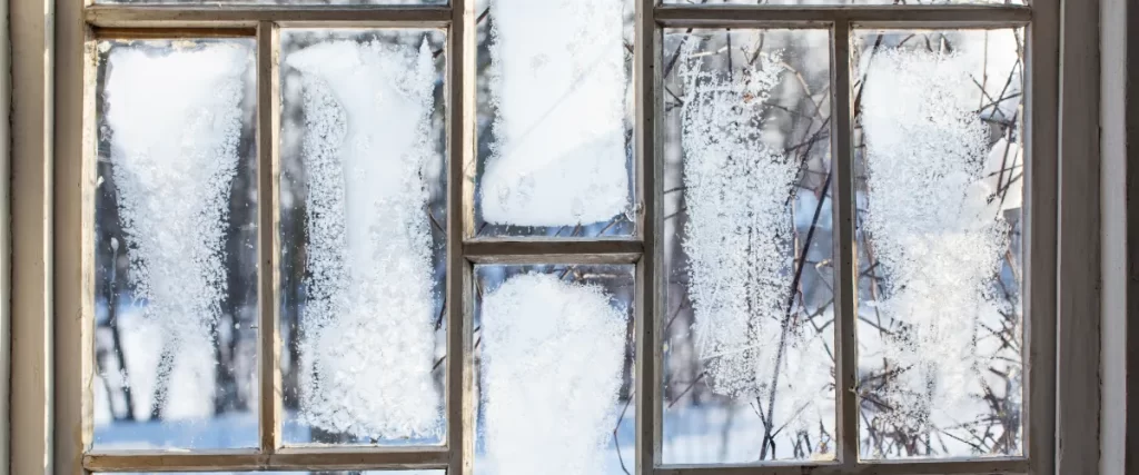 frost on the inside of an old wooden window
